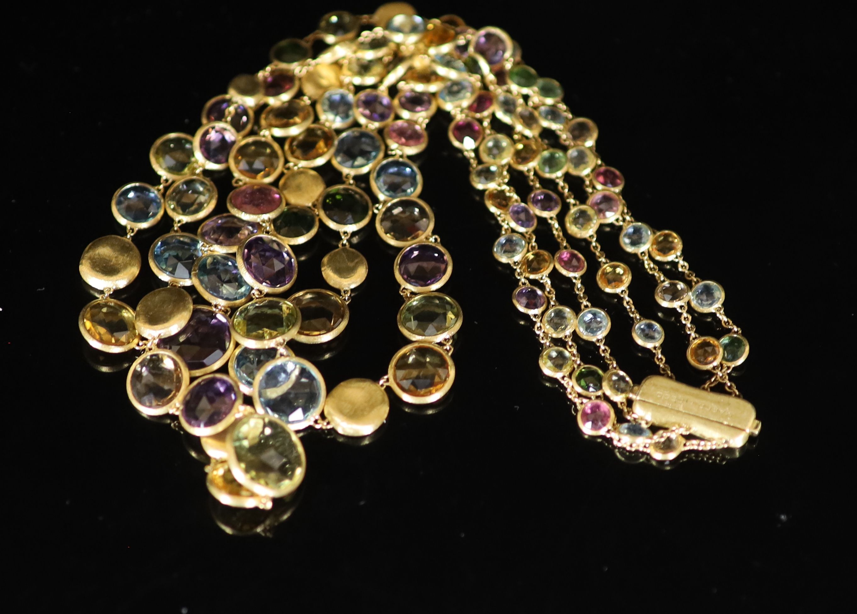 A modern Italian gold and graduated multi gem set three row spectacle necklace by Marco Bicego